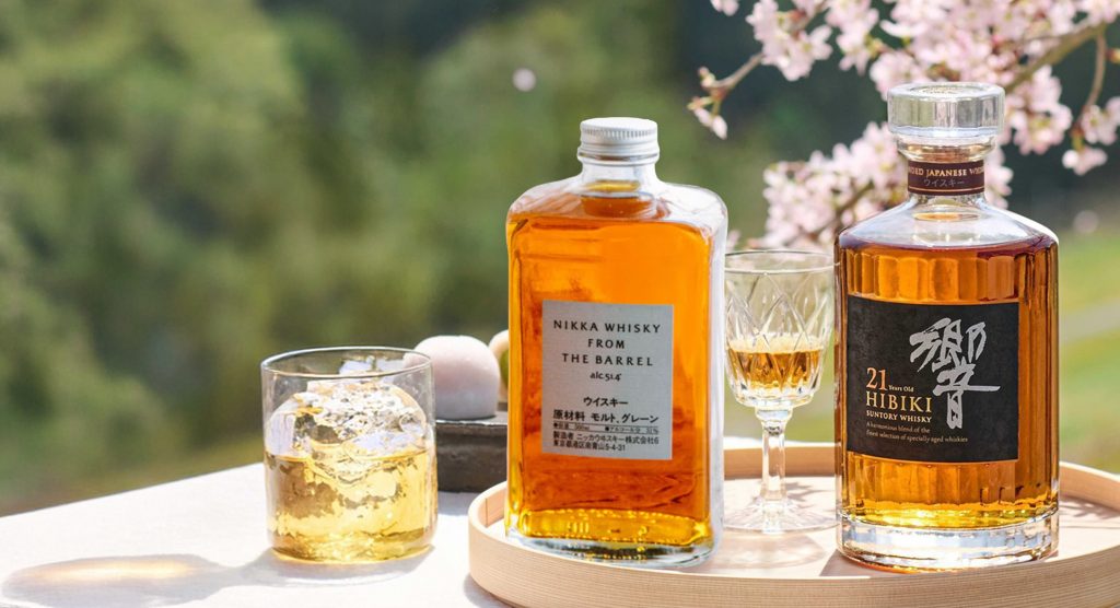 A serving of Japanese whiskies in a pink blossom tree garden.